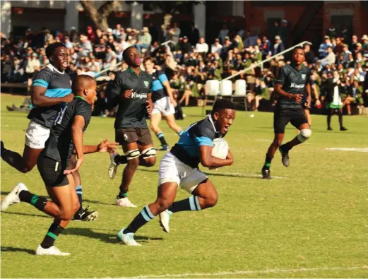  ?? Photo: Supplied ?? A St Andrew’s player heads to the scoring line as Cambridge High School players try to stop him.