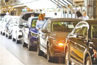  ?? FILE PHOTO BY JOE DODD/AP IMAGES FOR VOLKSWAGEN ?? Volkswagen assembly workers inspect vehicles in Chattanoog­a in 2016.