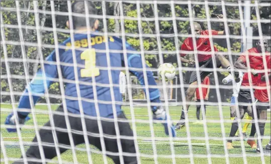  ?? Photos by Jenn March / Special to the Times Union ?? Lazaar Assofi, goalkeeper for the Michigan team, moves to stop a shot during his team’s game against Arizona at the Sudanese American Soccer Federation tournament at Afrim’s Sports Park in Colonie on Saturday.