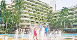  ??  ?? Children playing by the pool at a Shangri La Hotel.