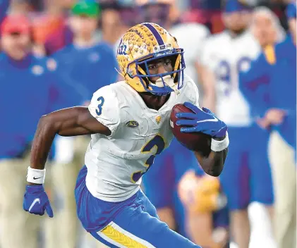  ?? ADRIAN KRAUS/AP ?? Pittsburgh wide receiver Jordan Addison runs with the ball during the second half against Syracuse in Syracuse, N.Y., on Nov. 27.