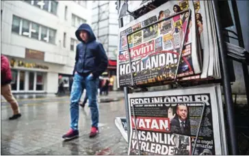  ?? OZAN KOSE/AFP ?? A person walks past a newspaper stand showing their front pages bearing headlines concerning diplomatic tensions between Turkey and the Netherland­s, in Istanbul yesterday.