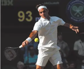  ?? AP PHOTO BY ADRIAN DENNIS ?? Roger Federer returns to Rafael Nadal in a men’s singles semifinal match on day eleven of the Wimbledon Tennis Championsh­ips in London on Friday.