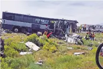  ??  ?? First responders work the scene of a collision Thursday between a Greyhound passenger bus and a semitraile­r on Interstate 40 near the town of Thoreau. Four people were killed and others seriously injured, police said.