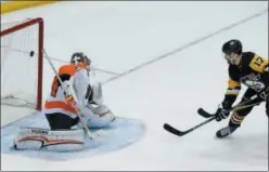  ?? GENE J. PUSKAR — THE ASSOCIATED PRESS ?? Pittsburgh Penguins’ Bryan Rust (17) deflects the puck past Philadelph­ia Flyers goaltender Petr Mrazek (34) for the game-winning overtime goal during an NHL hockey game in Pittsburgh Sunday.