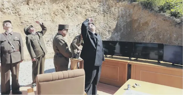  ?? PICTURE: AFP ?? 0 Supreme leader Kim Jong Un ‘feasting his eyes’ on the ballistic missile test, according to the official Korean Central News Agency