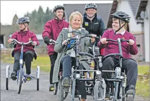  ??  ?? Roseanna Cunningham and children at Callander try out two-seater bikes.