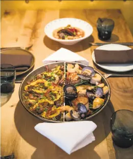  ?? Laura Morton / Special to The Chronicle 2016 ?? Two-in-one paella is an option at Bellota in S.F.: Pluma (left) and fideua.