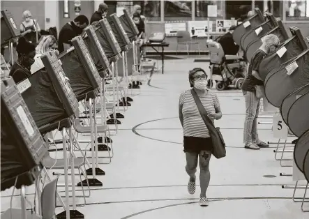  ?? Melissa Phillip / Staff photograph­er ?? With social distancing practices, most Harris County polling spots report a wait of around 40 minutes. Above, voting booths are spread out at the Metropolit­an Multi-Services Center during the first day of early voting Tuesday in Houston.