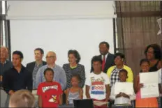  ??  ?? SUBMITTED IMAGE Assembly members Reed Gusciora and Elizabeth Muoio join Trenton Literacy Movement President Ed Bullock in congratula­ting students at closing ceremony for Summer Reading Program. Teacher Ms. Lafleur (far right) taught the students in the...