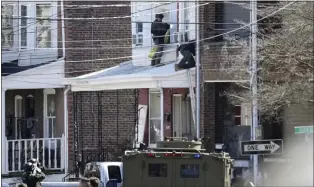  ?? MATT ROURKE - THE ASSOCIATED PRESS ?? Police surround a home in Trenton on March 16where a suspect was holding hostages after shooting three people to death in Pennsylvan­ia, authoritie­s said.