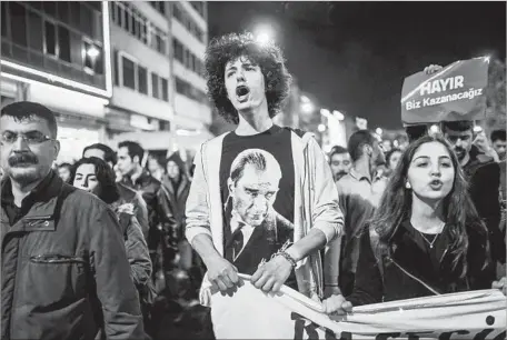  ?? BULENT KILIC AFP/GETTY IMAGES ?? IN ISTANBUL, supporters of the “no” campaign protest the results of a referendum that will give Turkey’s president more power. The “yes” side narrowly prevailed, but the opposition demanded an annulment, saying the rules for counting ballots were...