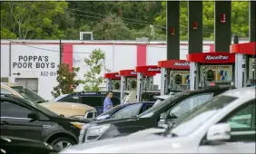  ?? CHRIS GRANGER — THE TIMES-PICAYUNE — THE NEW ORLEANS ADVOCATE VIA AP ?? Long lines are seen at a gas station in Jefferson, La., as people prepare for the arrival of Hurricane Ida on Friday, Aug. 27.