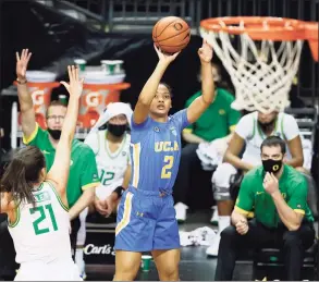  ?? Soobum Im / Getty Images ?? UCLA’s Dominique Darius (2) shoots over Oregon’s Erin Boley (21) earlier this month.