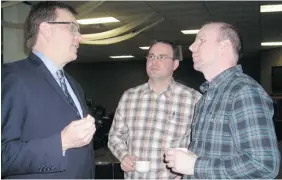  ??  ?? Lawyer Keith Wilson, left, speaks with clients Alain and Brian Labrecque, right,
at a public hearing in Peace River, Alta.