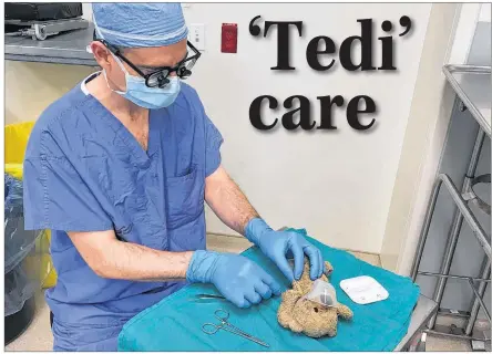  ?? THE CANADIAN PRESS/MOSAAB ALSUWAIHEL ?? Halifax-based neurosurge­on Daniel McNeely repairs a Summerside boy’s teddy bear while the patient was recovering from surgery.