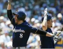  ?? NAM Y. HUH — THE ASSOCIATED PRESS ?? Milwaukee Brewers’ Ryan Braun, left, celebrates with Hernan Perez after hitting a two-run home run against the Chicago Cubs during the third inning of a baseball game Thursday in Chicago.