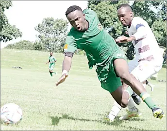  ?? (Pic: Mengameli Mabuza) ?? Manzini Wanderers midfielder and Captain Mlamuli ‘Mlaba’ Nkambule (R) tackles Tambuti FC striker, Banele Shongwe during yesterday afternoon’s MTN Premier League game at Mhlume’s Nsukuwansu­ku Stadium.Tambuti won the game 3-1.