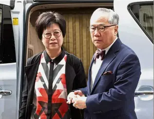  ?? — AP ?? Anxious times: Tsang and his wife Selina arriving at the High Court in Hong Kong. He was later rushed to hospital as he felt unwell.