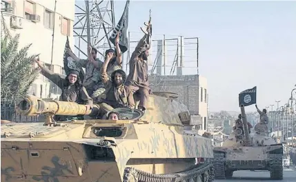  ?? AP ?? Fghters from the Islamic State group ride tanks during a parade in Raqqa, Syria. A major battle to liberate the northern Syrian city from Islamic State militants is looming, with US.officials looking to build on momentum from the battlefiel­ds in Mosul....