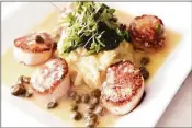  ?? ?? Capesante Picatta, pan-seared sea scallops, capers, garlic, lemon, butter and white wine served with sauteed spinach, prepared by chef Joe Dusa at Rosso Vino Wine Bar + Bistro in Branford.