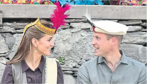  ??  ?? CROWNED HEADS: The couple were presented with Chitrali headdress and scarves and watched traditiona­l dance during the mountain visit