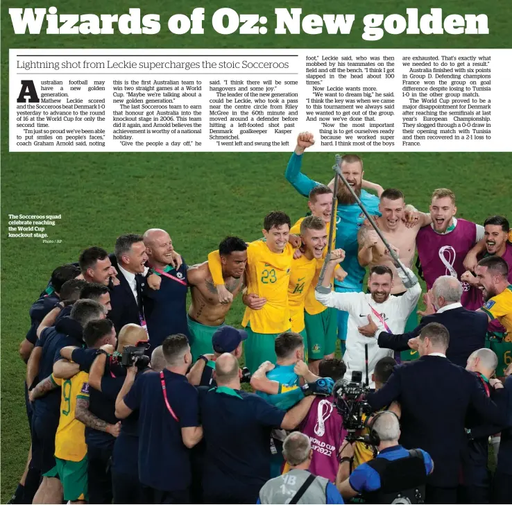  ?? Photo / AP ?? The Socceroos squad celebrate reaching the World Cup knockout stage.