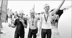  ??  ?? Faiq (left) and Hung Fai (right) with Live-Saving Society Butterwort­h chairman, Datuk Ooi Win Juat after completing the Oceanman Langkawi 2017. — Bernama photo
