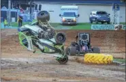  ?? CARL HESS - FOR DIGITAL FIRST MEDIA ?? Invader Holden Eckman (#11) and regular Shawn Rooney (#97) tangle exiting turn four during their 600Micro Sprint qualifier sending Eckman into the tractor tire, ultimately flipping his racer. The driver emerged unscathed.