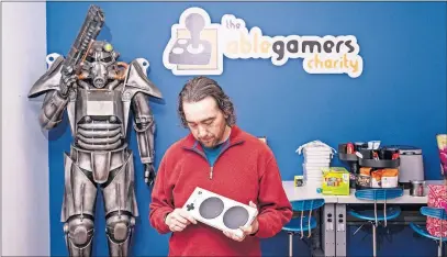  ?? [MATT ROTH FOR THE WASHINGTON POST] ?? Mark Barlet, founder and executive director of Ablegamers, holds a modified video game controller at the Ablegamers headquarte­rs in Harpers Ferry, West Virginia.