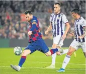  ?? AFP ?? Barcelona’s Lionel Messi scores his second goal against Real Valladolid.