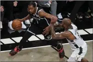  ?? FRANK FRANKLIN II - THE ASSOCIATED PRESS ?? Brooklyn Nets’ Kevin Durant, left, drives past Milwaukee Bucks’ P.J. Tucker during the first half of Game 7of a second-round NBA basketball playoff series Saturday, June 19, 2021, in New York.