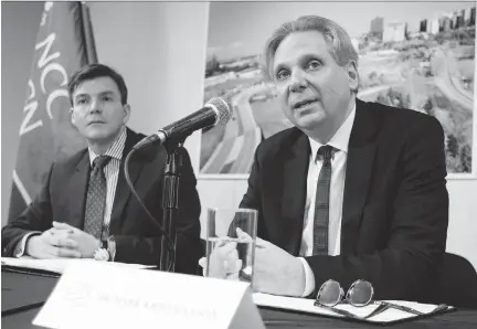  ??  DARREN BROWN/OTTAWA CITIZEN ?? The National Capital Commission’s Pierre Lanctot, executive director of corporate services, left, looks on as Mark Kristmanso­n, NCC CEO, speaks during a press conference to announce the shortlist of developers for LeBreton Flats on Wednesday.