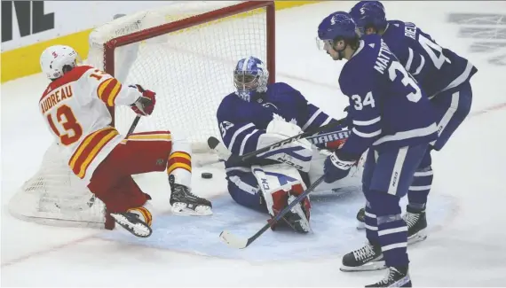  ?? JACK BOLAND ?? Johnny Gaudreau beats his former teammate David Rittich in overtime to give the Calgary Flames a 3-2 win over the Maple Leafs in Toronto Tuesday night.