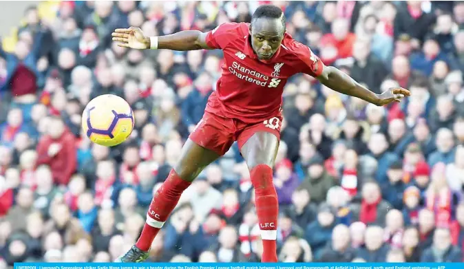  ??  ?? LIVERPOOL: Liverpool’s Senegalese striker Sadio Mane jumps to win a header during the English Premier League football match between Liverpool and Bournemout­h at Anfield in Liverpool, north west England yesterday. — AFP