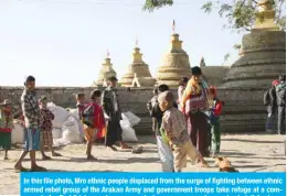  ?? — AFP ?? In this file photo, Mro ethnic people displaced from the surge of fighting between ethnic armed rebel group of the Arakan Army and government troops take refuge at a compound of a Buddhist pagoda are seen during a government-organized visit for journalist­s in Buthidaung township in the restive Rakhine state.