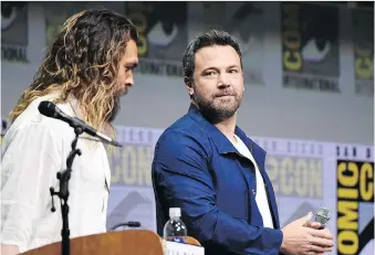  ?? RICHARD SHOTWELL/THE ASSOCIATED PRESS ?? Ben Affleck, right, seen with Jason Momoa during a Comic-Con Internatio­nal panel over the weekend, says despite rumours to the contrary he will play Batman in an upcoming film.