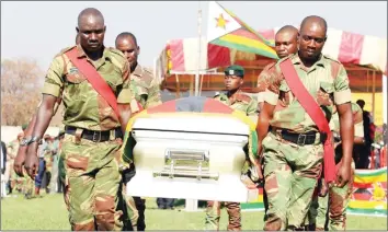  ??  ?? Pallbearer­s carry a casket bearing the body of national heroine Cde Thokozile Mathuthu at the Hwange Colliery Stadium yesterday