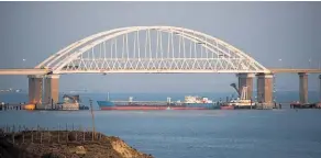  ?? Photos / AP ?? Russia has placed a large cargo vessel beneath a Russian-controlled bridge to close the Kerch Strait.