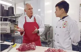  ??  ?? Chef Anton gets tips from Master Butcher Abe on the finer points of trimming Canada beef