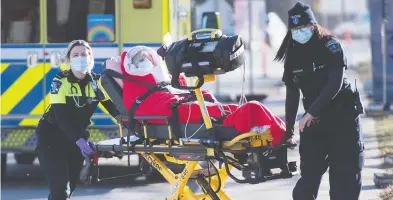  ?? THE CANADIAN PRESS/FILES ?? Paramedics wheel a patient into the emergency department at Mount Sinai Hospital in Toronto last month. Canada has been recording a rise in COVID-19 variants, including a type that originally spread in the U.K.