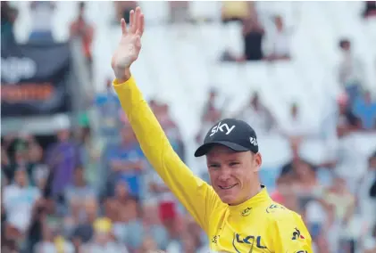  ??  ?? Britain’s Chris Froome, wearing the overall leader's yellow jersey, celebrates on the podium after the twentieth stage of the Tour de France Photo: AP