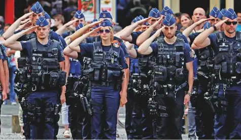  ?? Reuters ?? Police officers observe a minute of silence in Liege yesterday, after two policewome­n and a bystander were killed on Tuesday.