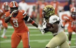  ?? DENNIS NETT ?? Wake Forest Demon Deacons running back Christian Beal-Smith (26) during the first half of an NCAA college football game against Syracuse on Saturday, Oct. 31, 2020, in Syracuse, N.Y.