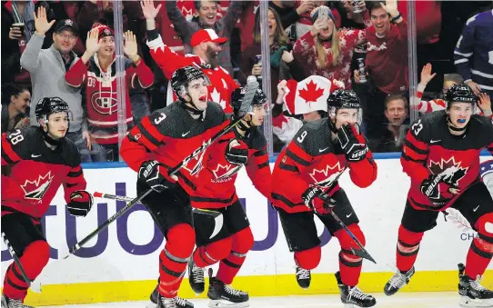  ?? JEFFREY T. BARNES/ THE ASSOCIATED PRESS ?? Members of Team Canada celebrate a goal late in Friday night’s gold-medal game against Sweden in Buffalo, N.Y., en route to a 3-1 win. The Canadians won the tournament a year after losing in a shootout in the 2017 final against the United States.