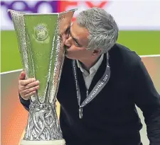  ??  ?? Manchester United manager Jose Mourinho kisses the Europa League trophy in Stockholm.