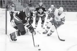  ?? GREGORY SHAMUS Getty Images ?? Florida’s Anton Stralman (6) looks to pass around Detroit’s Darren Helm (43) during the second period at Little Caesars Arena.