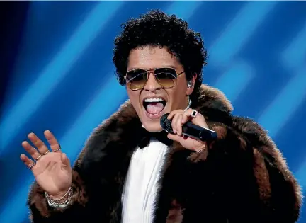 ?? PHOTO; REUTERS ?? Bruno Mars even has a dress code when it comes to recording music.