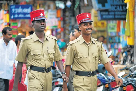  ?? Picture: GALLO/GETTY ?? MIND THE KEPI: Police in Pondicherr­y, renamed Puducherry, smile and keep the peace