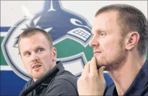  ?? CP PHOTO ?? Vancouver Canucks Henrik, right, and Daniel Sedin announce their retirement­s from hockey during a news conference at Rogers Arena in Vancouver, Monday.